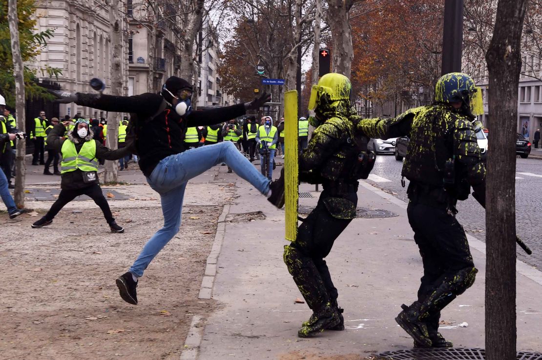 A demonstrator clashes with riot police in Paris, on December 1, 2018.
