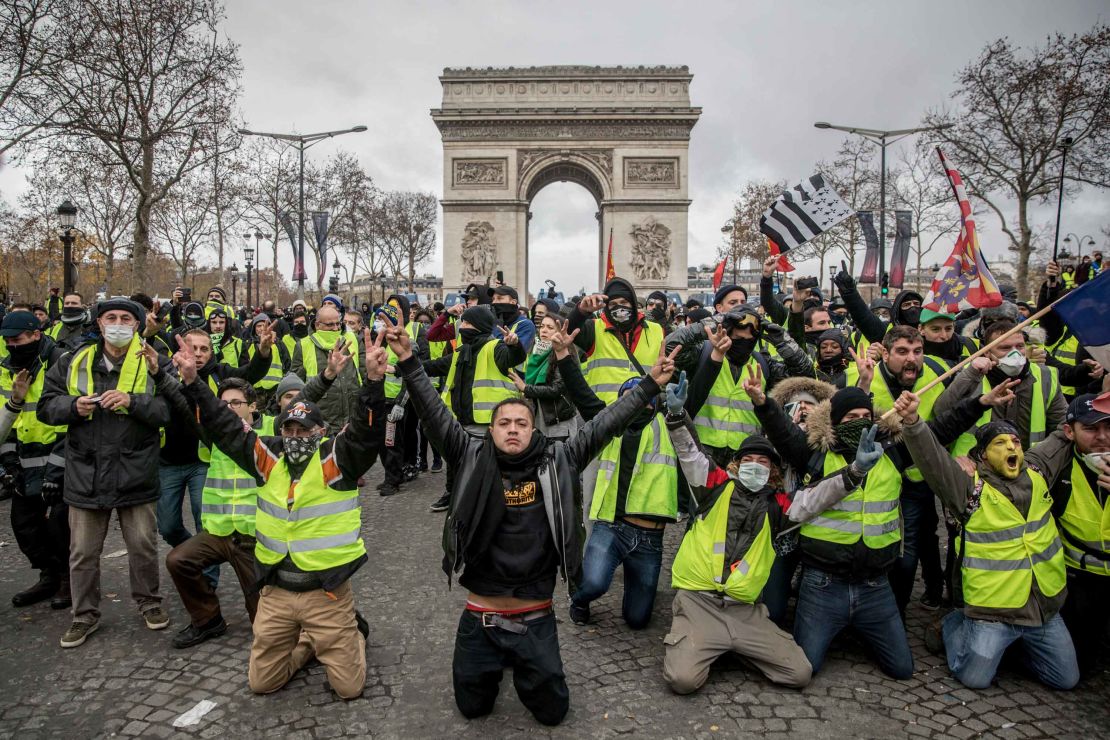 Protesters chant slogans during the  demonstration on the Champs-Elysées near the Arc de Triomphe on December 8, 2018 in Paris.