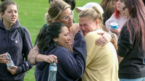 Students are comforted as they wait to be reunited with their parents on Thursday, November 14, following a shooting at Saugus High School in Santa Clarita, California.