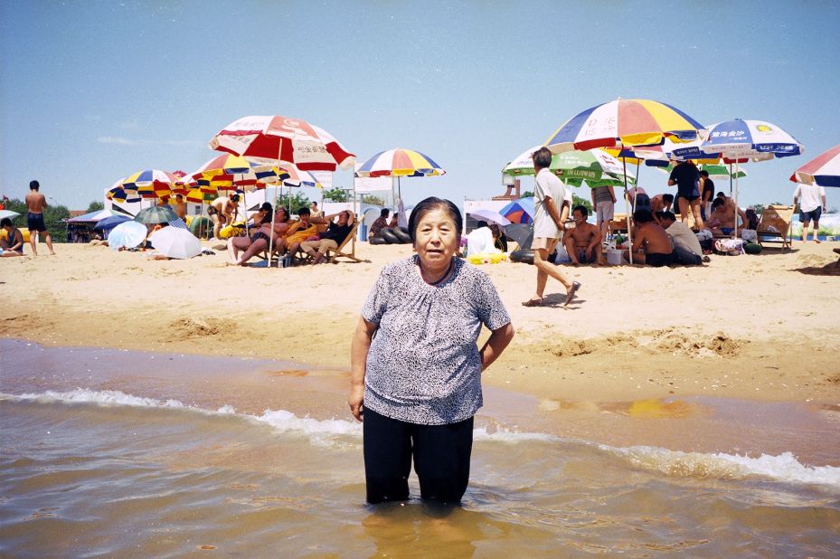 Many of the found photos depict people on holiday, such as this unidentified woman at a beach.