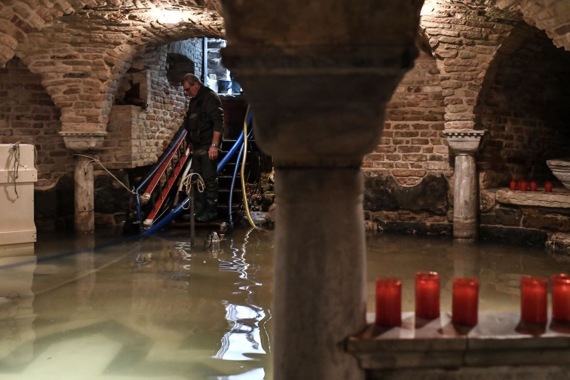 A man pumps out water from the flooded crypt of St. Mark's Basilica on November 13.