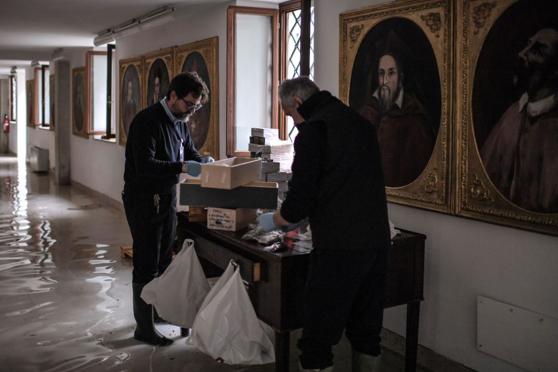 People assess damages in a wing of St. Mark's Basilica that houses various objects as key rings, rosaries, crosses on Wednesday, November 13.