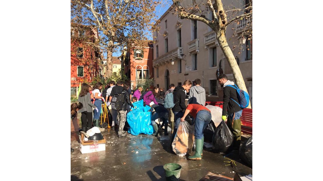 Volunteers clean up flooded Venice.