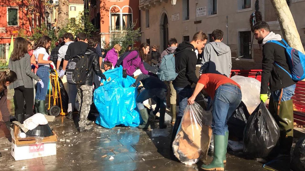 Volunteers clean up flooded Venice.