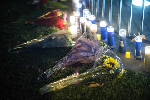 People affected by the Saugus High School shooting leave candles and flowers during a vigil at Central Park in Santa Clarita.