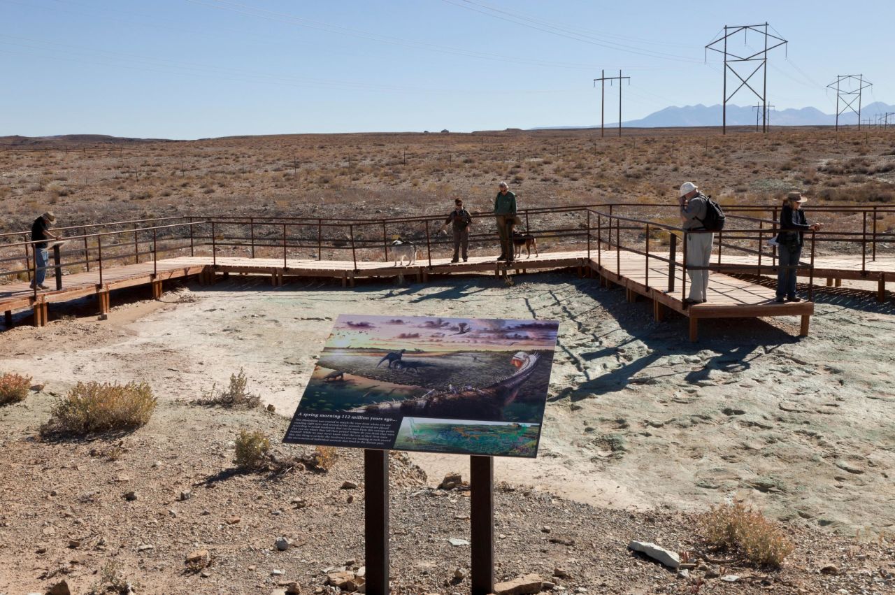 Visitors to the Mill Canyon dinosaur track site can walk along an elevated boardwalk above Early Cretaceous-era tracks and contemplate illustrations such as this one by artist Brian Engh.