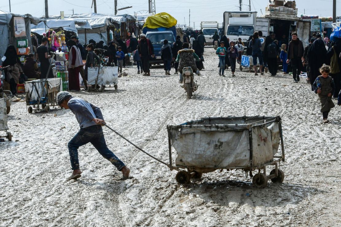 A boy pulls a cart in al-Hol camp which houses thousands of relatives of ISIS group members in northeastern Syria.