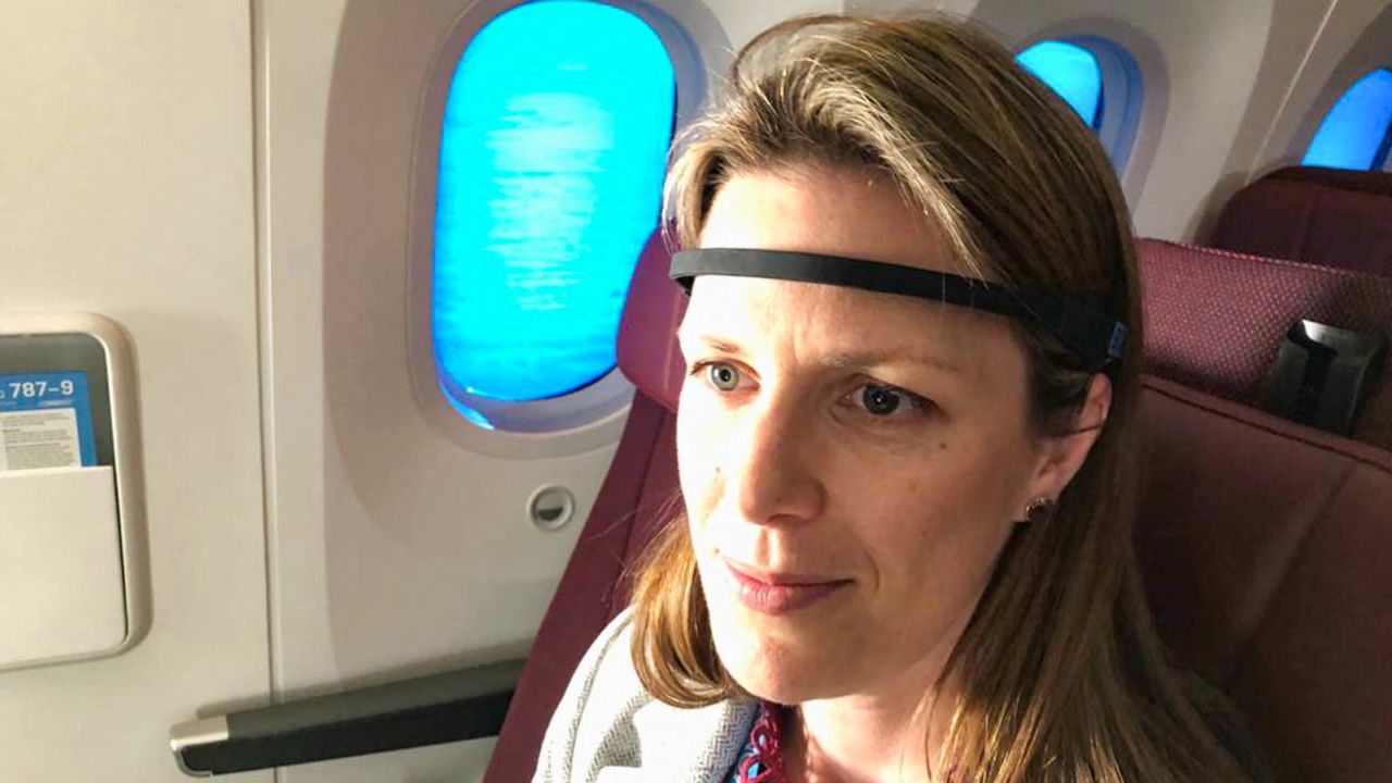 Tracey Sletten demonstrates a brainwave tracker in use on the flight.