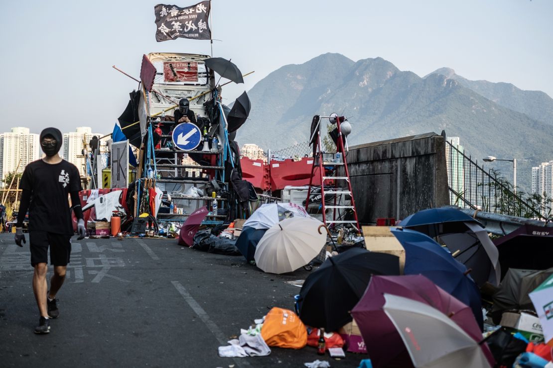 A demonstrators sits on a makeshift watchtower while occupying the No. 2 Bridge during a protest at the Chinese University of Hong Kong (CUHK) in Hong Kong on November 15, 2019.