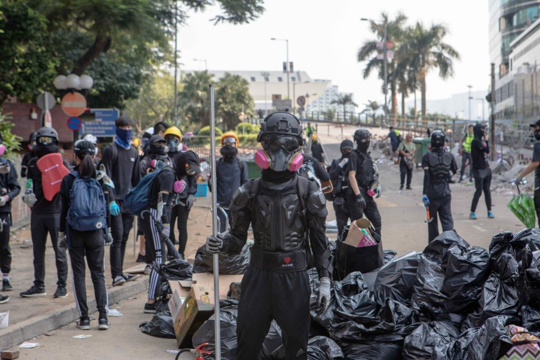 Protesters stand guard at the entrance to Hong Kong Polytechnic University (PolyU) on November 15, 2019.