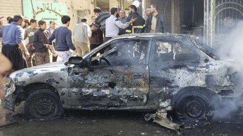 This photo provided by the Syrian anti-government activist group Albab City, which has been authenticated based on its contents and other AP reporting, people check the aftermath of a car bomb exploded in the city of al-Bab, northern Syria, Saturday, Nov. 16, 2019. A car bomb exploded Saturday in a northern Syrian town controlled by Turkey-backed opposition fighters, killing at least 18 people and wounding several others, Syrian opposition activists and Turkey's Defense Ministry said. (Albab City via AP)