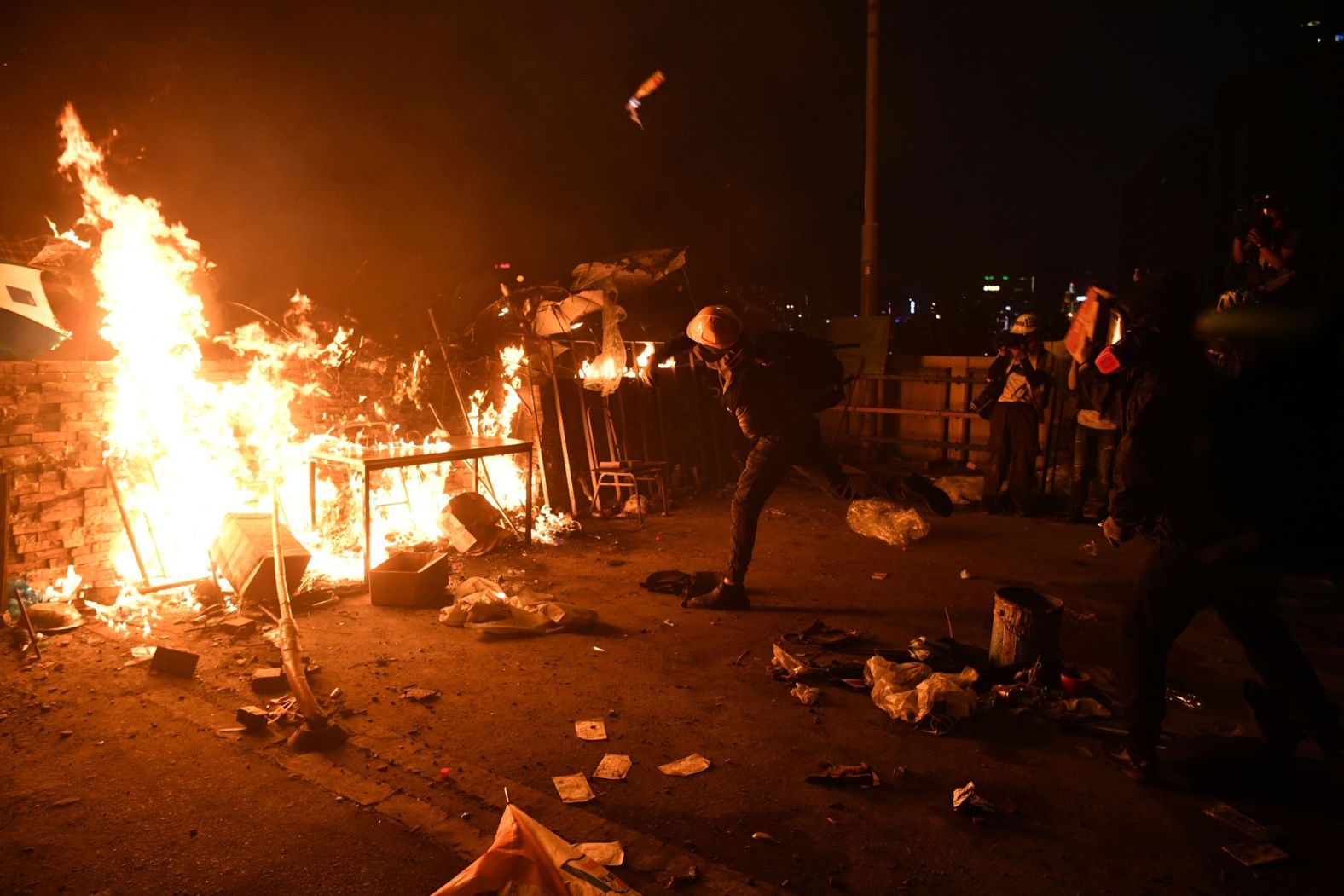 A protester throws a Molotov cocktail at police on November 17.