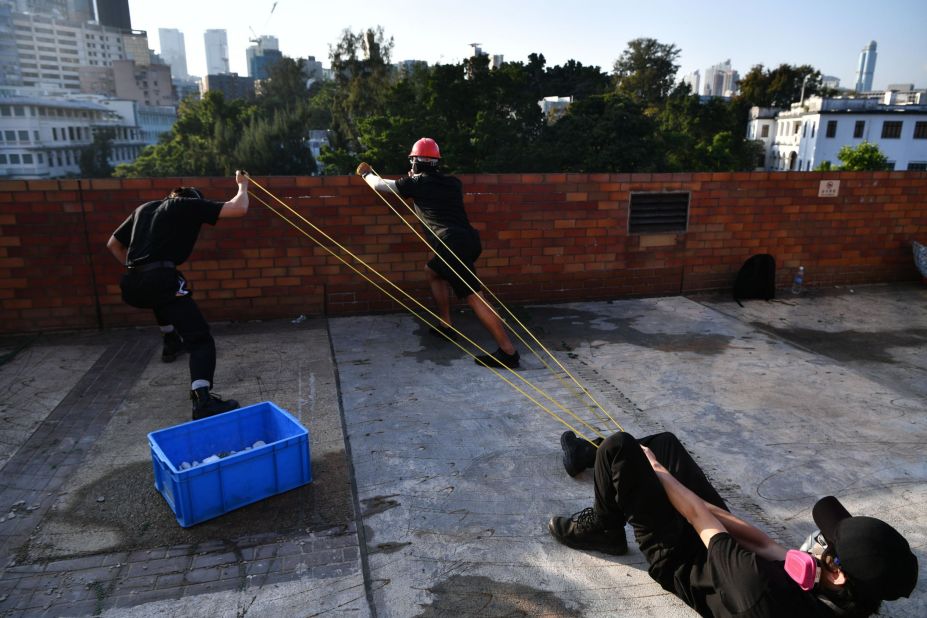 Protesters use a catapult to fire bricks at the police from inside the Hong Kong Polytechnic University on November 17.