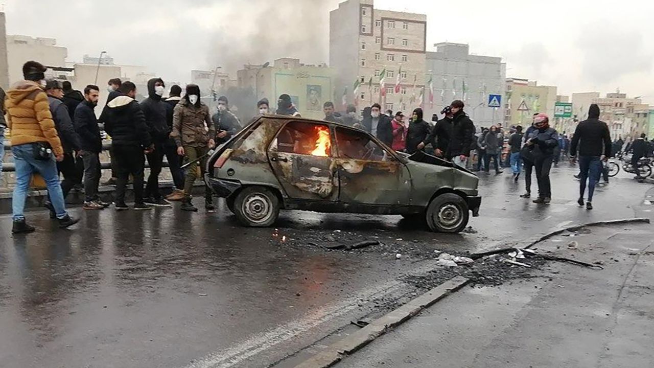 Iranian protesters gather around a burning car during a demonstration against an increase in gasoline prices in the capital Tehran on November 16, 2019.