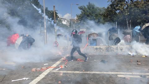 A protester reacts from tear gas fired by police at the Hong Kong Polytechnic University on Sunday afternoon.