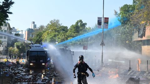 Police launch water cannons and tear gas outside the Hong Kong Polytechnic University in an attempt to disperse protesters on Sunday.