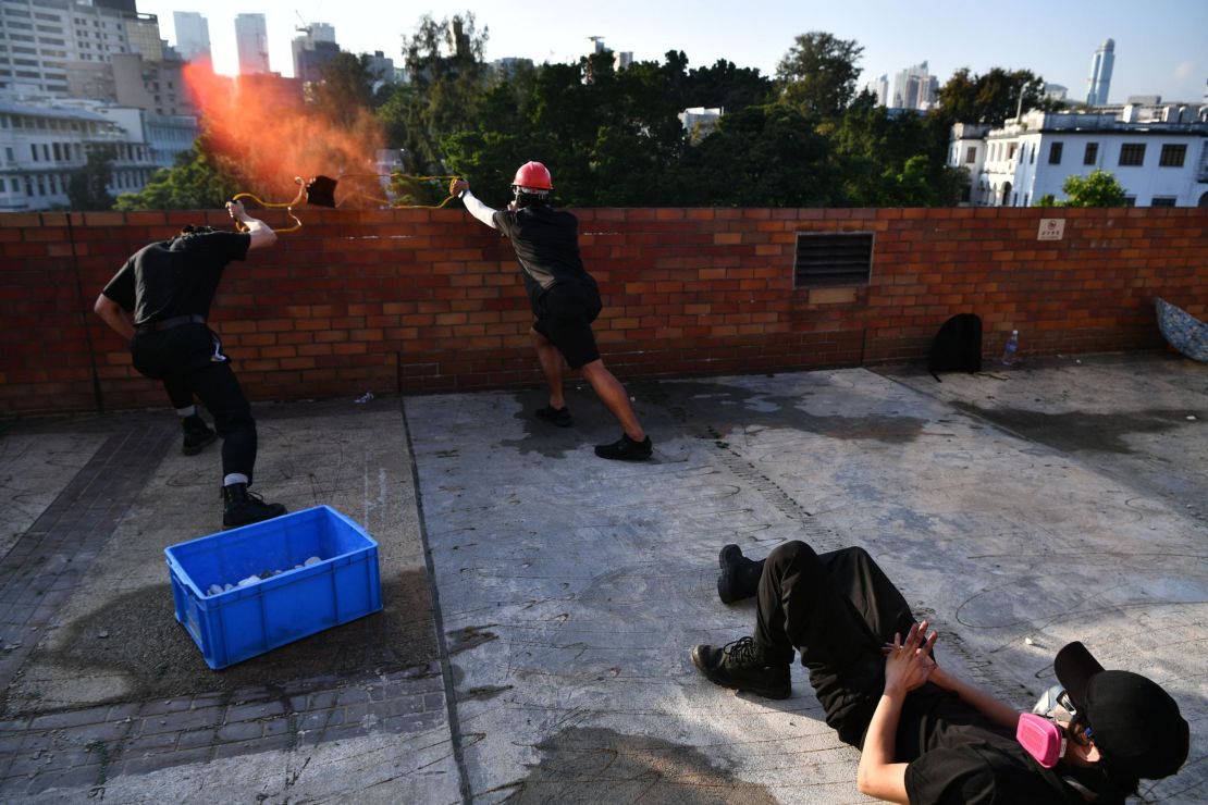 Protesters use a catapult to fire objects at police from inside the Hong Kong Polytechnic University on Sunday.