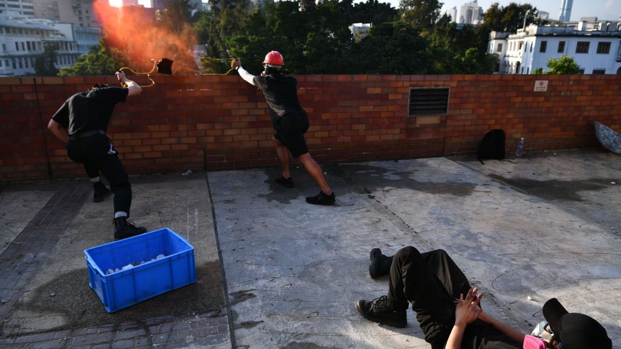 Protesters use a catapult to fire objects at police from inside the Hong Kong Polytechnic University on Sunday.