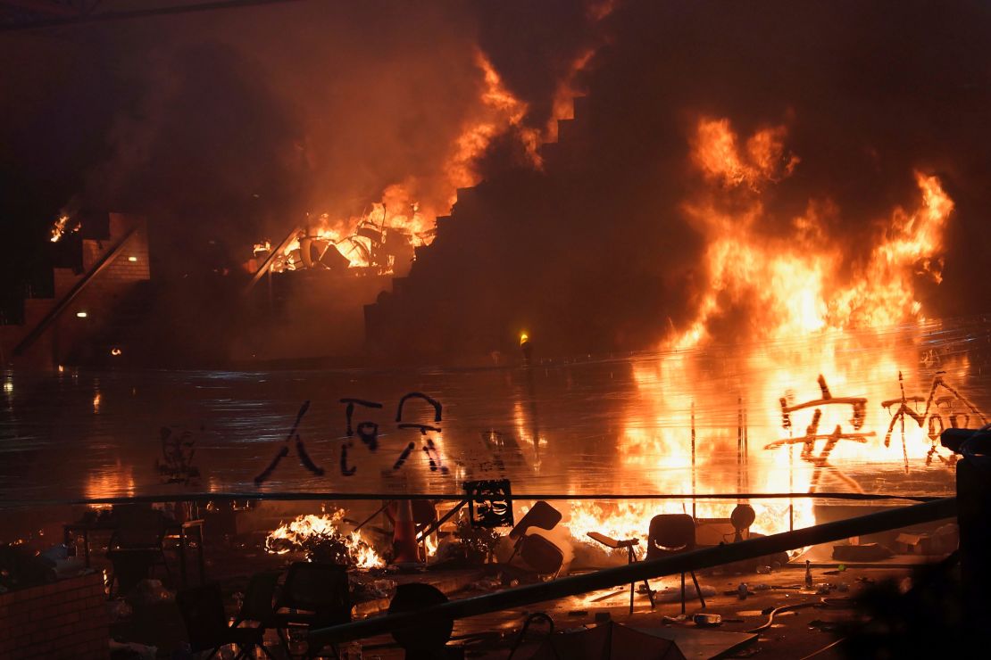 A massive fire burns at the steps leading to Hong Kong Polytechnic University, as clashes continued to rage early Monday.