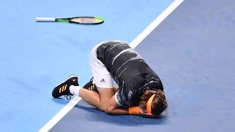 Stefanos Tsitsipas sinks to the ground after match point at the ATP Finals. 