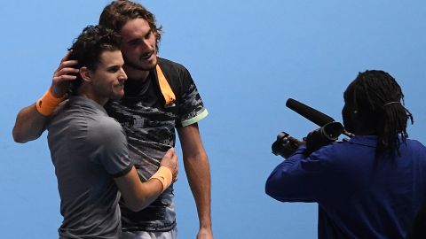 Stefanos Tsitsipas and Dominic Thiem (front) exchange a hug after their ATP Finals thriller. 