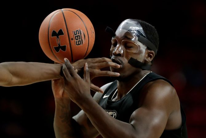 Oakland forward Xavier Hill-Mais has the ball hit out of his hands by Maryland forward Jalen Smith during the first half of an NCAA basketball game in College Park, Maryland, on Saturday, November 16.