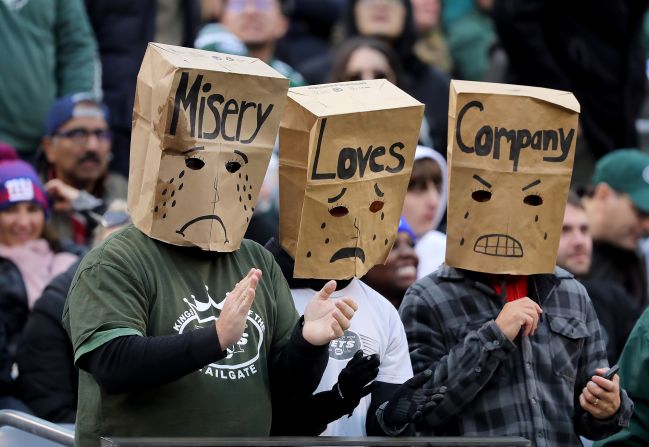 New York Jets fans put bags over their heads during the third quarter of an NFL football game against the New York Giants in East Rutherford, New Jersey, on Sunday, November 10.