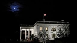 The moon shines through clouds over the White House in Washington, late Tuesday, Nov. 12, 2019. The public impeachment inquiry hearings set to begin Wednesday will pit a Democratic attorney who built his reputation as a federal mob and securities fraud prosecutor against a GOP House Oversight investigator who helped steer some of the most notable probes of the Obama administration. (AP Photo/Patrick Semansky)