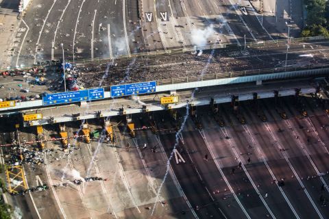 Police fire tear gas as protesters attempt to leave Hong Kong Polytechnic University via a bridge on November 18.