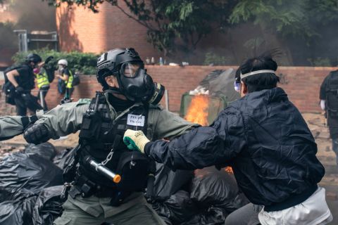 A member of the police clashes with a protester at the Hong Kong Poytechnic University on November 18.