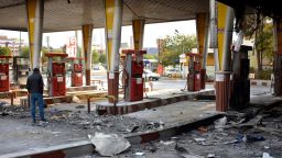 An Iranian man checks a scorched gas station that was set ablaze by protesters during a demonstration against a rise in gasoline prices in Eslamshahr, near the Iranian capital of Tehran, on November 17, 2019. - President Hassan Rouhani warned  that riot-hit Iran could not allow "insecurity" after two days of unrest killed two people and saw authorities arrest dozens and restrict internet access. Rouhani defended the controversial petrol price hike that triggered the protests -- a project which the government says will finance social welfare spending amid a sharp economic downturn (Photo by - / AFP) (Photo by -/AFP via Getty Images)
