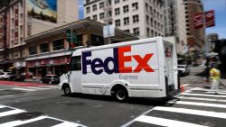 SAN FRANCISCO, CALIFORNIA - JUNE 25: A FedEx delivery truck drives along Geary Street on June 25, 2019 in San Francisco, California. FedEx is suing the US Department of Commerce for requiring the shipping company to implement extra screening efforts to enforce export bans. Due in part to the ongoing trade war with China and potential security threats, the U.S. government has imposed several restrictions on companies that deal with Chinese electronics company Huawei. (Photo by Justin Sullivan/Getty Images)