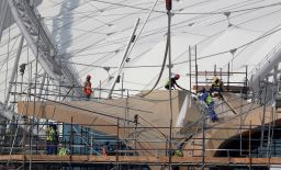 Workers are pictured on scaffolding at the Khalifa International Stadium in Doha.