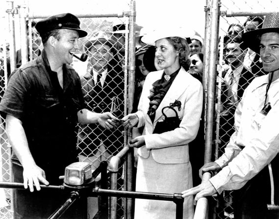 Bing Crosby greets a guest through the turnstile on opening day at the Del Mar racecourse in 1937.