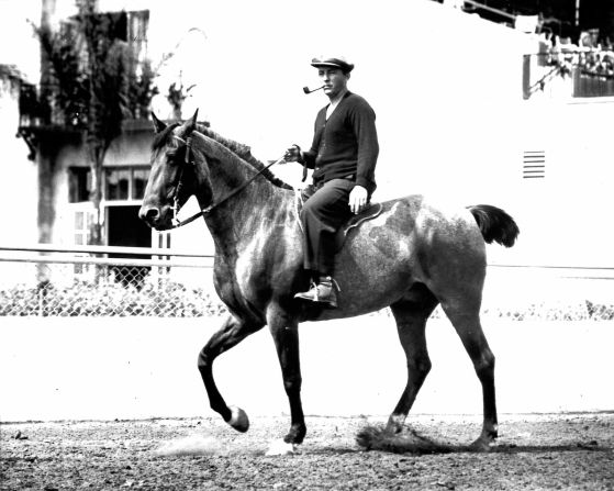 Bing Crosby pictured on horseback at the Del Mar racetrack in 1938.