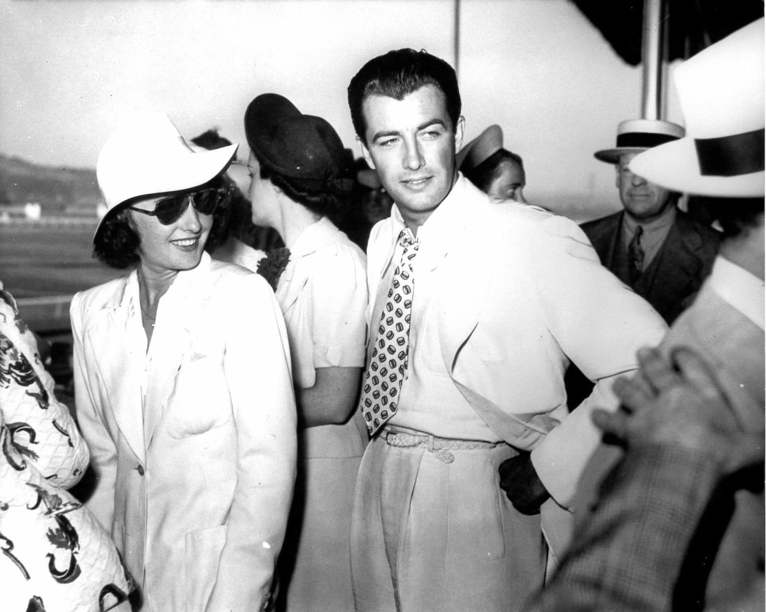 Barbara Stanwyck and Robert Taylor enjoy a day at the races.
