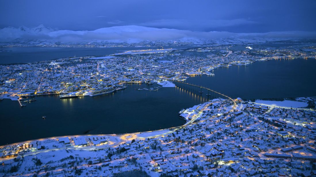 <strong>Tromso, Norway:</strong> There's nothing like the melancholy  beauty of a deep winter blue -- this is a general view of Tromso on January 19, 2019, during its long polar night. For those open to winter travel, the splendors of this northern Norwegian outpost are many.