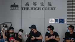 A group of protesters rest outside the High Court in Hong Kong on June 21, 2019. - Thousands of protesters converged on Hong Kong's police headquarters and blocked major roads on June 21, demanding the resignation of the city's pro-Beijing leader and the release of anti-government demonstrators arrested during the territory's worst political crisis in decades. (Photo by Philip FONG / AFP)        (Photo credit should read PHILIP FONG/AFP via Getty Images)