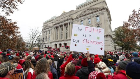 Thousands of teachers wearing red surround the Indiana Statehouse in Indianapolis on Tuesday.