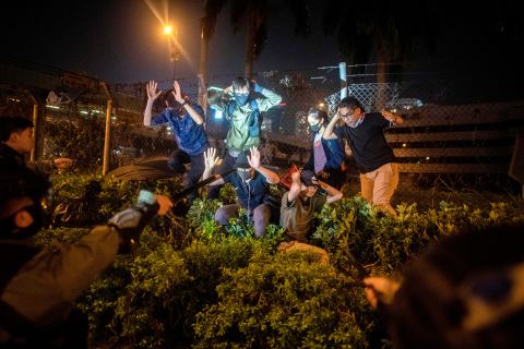 Police detain a group of people after they tried to flee the Hong Kong Polytechnic University campus on November 19. Last week, thousands of student protesters streamed into the <a href=