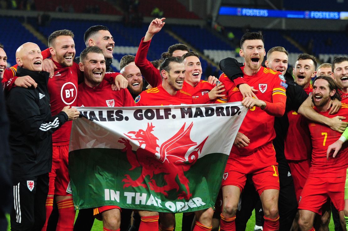 Wales celebrate with the infamous "Wales. Golf. Madrid flag."