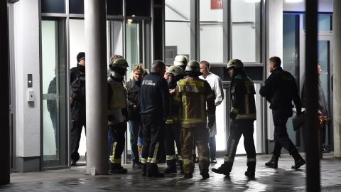Policemen, firefighters and medical staff in front of Schlosspark-Klinik hospital in Berlin after a doctor who was giving a lecture was stabbed to death Tuesday. 