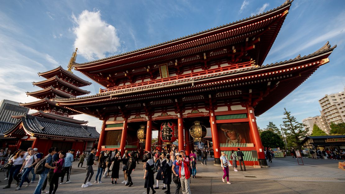 The bright red Senso-ji temple is punctuated by the adjacent five-story pagoda.
