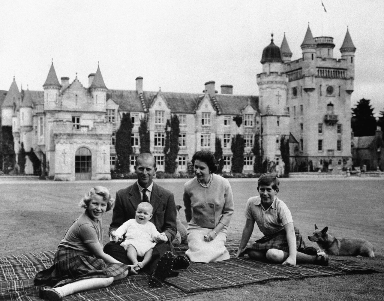 Prince Andrew sits on his father's lap during a holiday in Scotland in September 1960. At left is his sister, Princess Anne. At right, next to the Queen, is his brother Prince Charles.