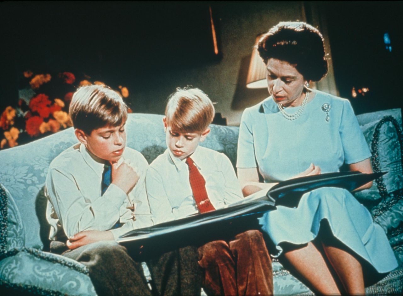 The Queen looks at a photo album with Andrew, left, and Edward in 1971.