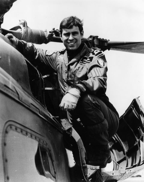 Prince Andrew poses next to a helicopter in 1982.