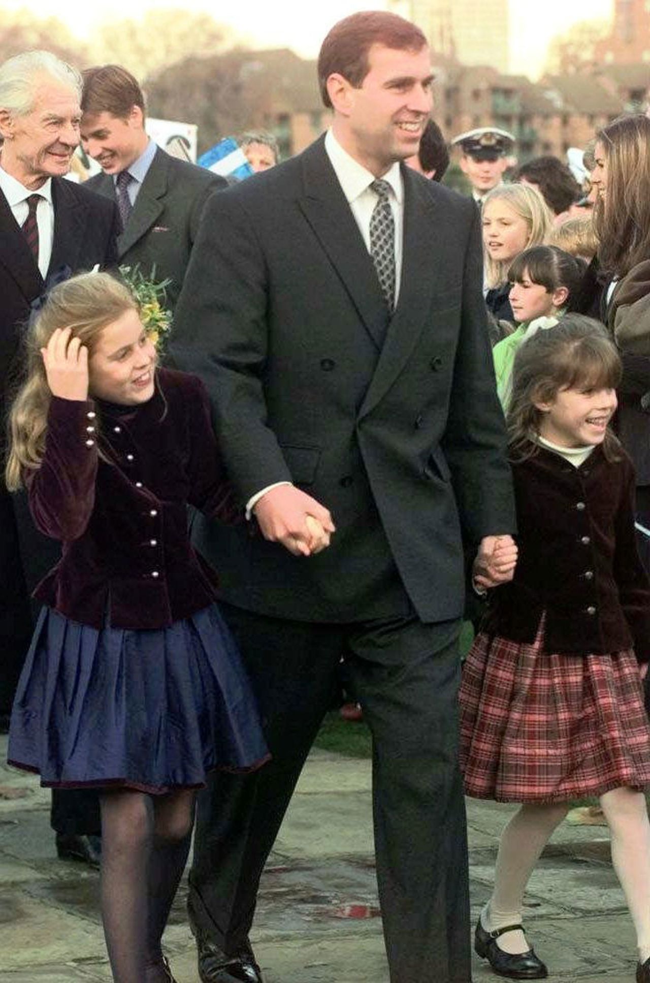 Prince Andrew holds hands with his two daughters, Beatrice and Eugenie, after arriving for a dinner in London in 1997.