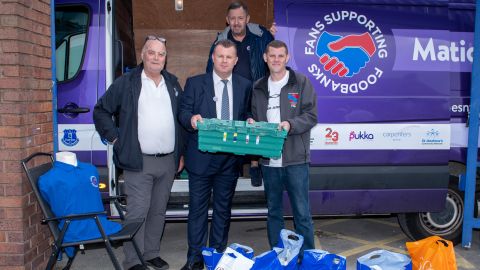 Dave Kelly (L) and former Everton player Graham Stuart collect donations outside Goodison Park.
