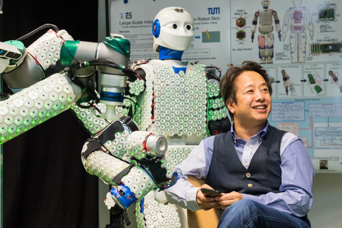 Professor Gordon Cheng with the H-1 robot, covered in 13,000 sensors that enable tactile sensation
