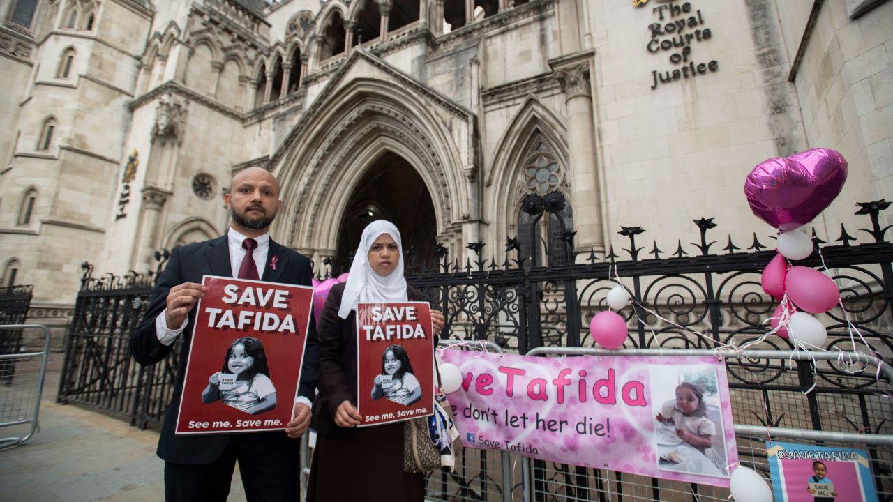 Shelina Begum and husband Mohammed Raqeeb stand at the Royal Courts of Justice in London in September.